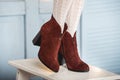 Womens brown suede fashion boots . slender female legs in white tights Royalty Free Stock Photo