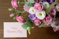 Womens day card. Bouquet of pink roses in basket on wooden background closeup