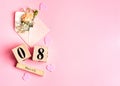 Womens day composition. 8 march wooden calendar with flowers in an envelope on the pink background. Copy space, top view