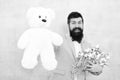 Womens day. Formal businessman with teddy bear toy. spring bouquet. 8 of march. bride groom at wedding party. bearded