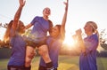 Womens Football Team Celebrating Winning Soccer Match Lifting Player Onto Shoulders Royalty Free Stock Photo