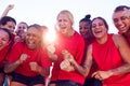 Womens Football Team Celebrating Winning Soccer Match On Outdoor Astro Turf Pitch