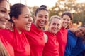 Womens Football Team Hugging After Training For Soccer Match On Outdoor Astro Turf Pitch