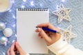 Womens hands over a white sheet of notebook, hold a blue fountain pen Royalty Free Stock Photo