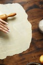 Womens hands roll out dough preparation apple strudel top view Royalty Free Stock Photo