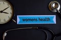 Womens Health on the print paper with Healthcare Concept Inspiration. alarm clock, Black stethoscope.