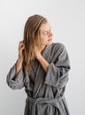 Happy young woman applying hair mask in bathroom Royalty Free Stock Photo