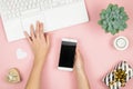 Womens home workspace. Girl Blogger works with phone and laptop. Freelance concept. Teleworker texting using laptop and