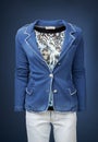 Womens jacket on a manequin isolated on a blue background.