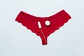 Womens lace red panties with medical female tampon against critical days on a blue background. Menstruation, means of protection Royalty Free Stock Photo