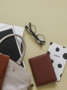 Womens office bag with work accessories on a yellow background, top view