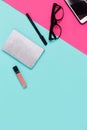 Womens office materials on pink and blue background. Flat lay, Top view
