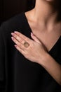 Womens Ring Of Rose Gold In The Form Of A Shell With A Pearl Of Stone  On The Finger, On A Black Background.