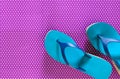 Womens shoes blue green flip flops on violet background in pol Royalty Free Stock Photo