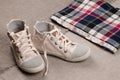 Womens sneakers and plaid shirt with lace insertion. Trendy lace