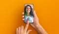 Womman holding cellphone in hand video calling distance friend