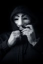 Womman wearing Vendetta mask. This mask is a well-known symbol for the online hacktivist group Anonymous