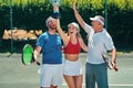 We won. a group of sportspeople celebrating a win after winning a trophy in a tennis match.