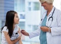 This won't hurt at all. Shot of a little girl getting a vaccination by a doctor in a hospital. Royalty Free Stock Photo