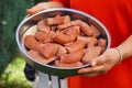 Wona holding platter with Raw Sausages prepared for the grill. Royalty Free Stock Photo