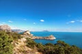 Wonderful beach with azure blue sea and green trees in clear sunny day. View from rock on beautiful coast bay Royalty Free Stock Photo