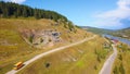 Wonderful bird's-eye view. Clip. A green hilly mountain on which there are roads with cars and a bus, on top of which Royalty Free Stock Photo