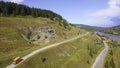 Wonderful bird's-eye view. Clip. A green hilly mountain on which there are roads with cars and a bus, on top of Royalty Free Stock Photo