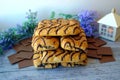 Wonderful biscuit cakes poured with chocolate stand on background