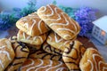 Wonderful biscuit cakes poured with chocolate stand on background