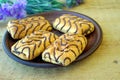 Wonderful biscuit cakes poured with chocolate stand on clay plate