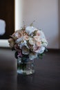 Wonderful bridal roses bouquet in a vase on the floor