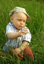 Wonderful child with a pliers in the green grass