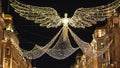 Wonderful Christmas street decoration in London flying angels made of light - LONDON, ENGLAND - DECEMBER 15, 2018
