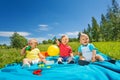 Wonderful cute toddlers sit on blanket in field