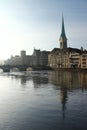 Wonderful day for sightseeing: Limmat river promenade in Zurich, Switzerland. Fraumuenster church.