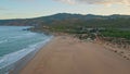 Wonderful evening beach seascape with coast washed by foamy blue ocean waves Royalty Free Stock Photo