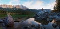 Wonderful evening scenery at lake Eibsee, Zugspitze mountains. young woman relax on a rock Royalty Free Stock Photo