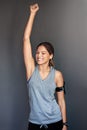 That wonderful feeling when you finally reach your goal...a sporty young woman raising her arm in excitement against a