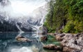 Wonderful foggy morning at Braies lake in Dolomites alps. Amazing nature landscape. lake and Seekofel mount on background in fog,