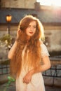 Wonderful ginger young woman with naked long wavy hair posing in