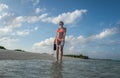 Wonderful girl in bikini with mask and pins in her hands is walking on the beach Royalty Free Stock Photo