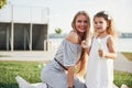 A wonderful girl child makes bubbles with her mom in the park. Royalty Free Stock Photo