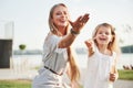 A wonderful girl child makes bubbles with her mom in the park. Royalty Free Stock Photo