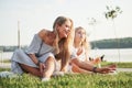 A wonderful girl child makes bubbles with her mom in the park. Royalty Free Stock Photo