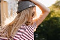 Wonderful girl with little tattoo on arm posing outdoor holding gray hat. Close-up portrait of inspired blonde female Royalty Free Stock Photo