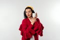 Wonderful happy young woman in red sweater holding a white cup of coffee and smiling at a camera on a white background Royalty Free Stock Photo