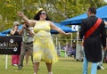 Confident, flamboyant, fun, happy plus-size woman modelling at dog show Royalty Free Stock Photo