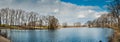 Wonderful landscape, early spring on a small lake, panorama. Reflection of reeds, sky and trees Royalty Free Stock Photo