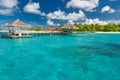 Luxury vacation. Tropical beach with water bungalows on the Maldives with seaplane and amazing blue sea Royalty Free Stock Photo