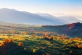 Wonderful landscapes with cities with fields and haystacks. Fruit trees with colored leaves. High mountains.